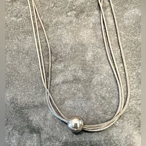 Silver triple strand necklace with silver ball finish.